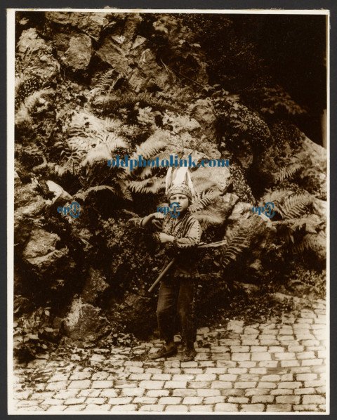 oy Dressed as an Indian Posed in Front of Ferns 1900